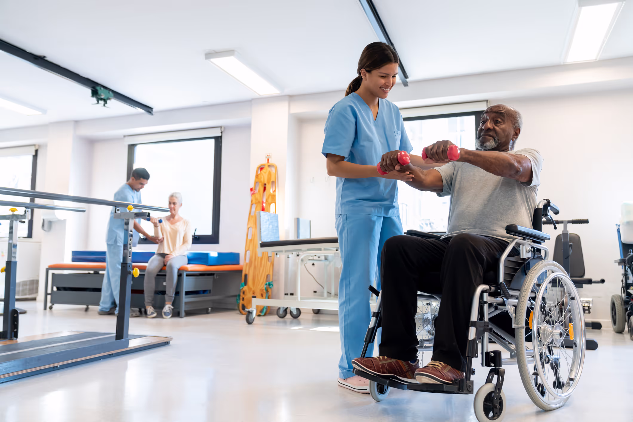Image of hospital worker helping a patient in a wheelchair